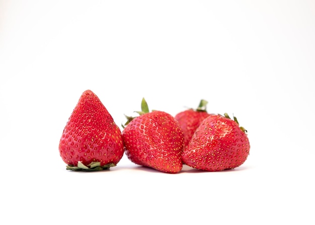 Three strawberries are on a white background.