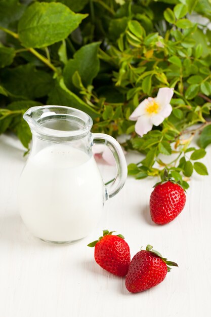 Three strawberries with milk