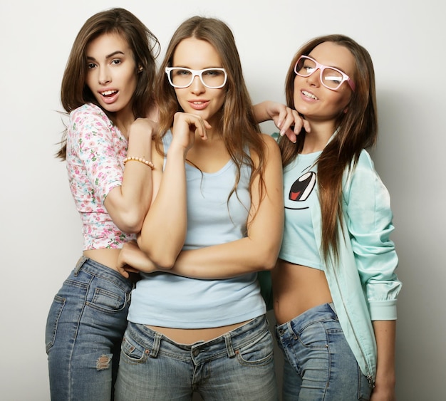 Tre ragazze alla moda sexy hipster migliori amici su sfondo bianco