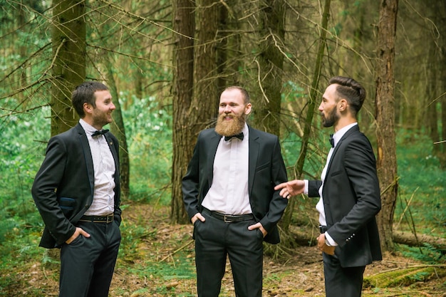 Three successful business partner to discuss current affairs in a pine forest