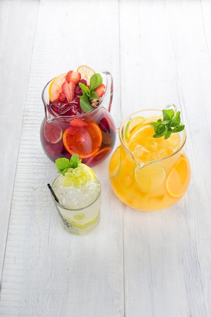 Three summer lemonade on a white wooden background