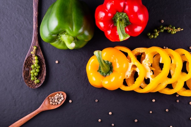 Three sweet peppers on a wooden background, Cooking vegetable salad