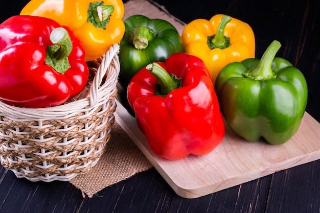 Three sweet peppers on a wooden background Cooking vegetable salad