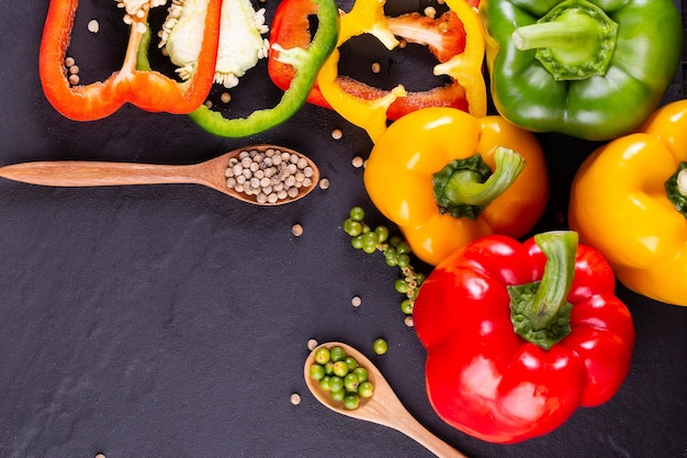 Three sweet peppers on a wooden background Cooking vegetable salad