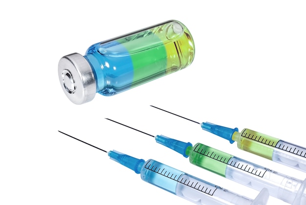 Three syringes with multicolored vaccine and medical vial on white background