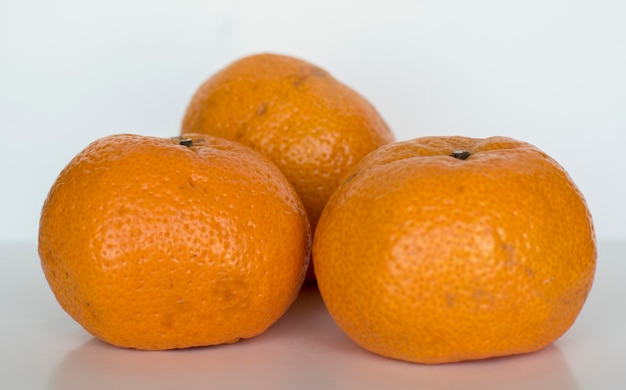 Three tangerines on a white background