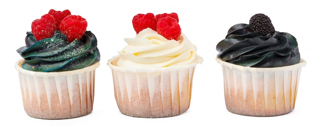 Three tasty cupcakes with cream topping isolated