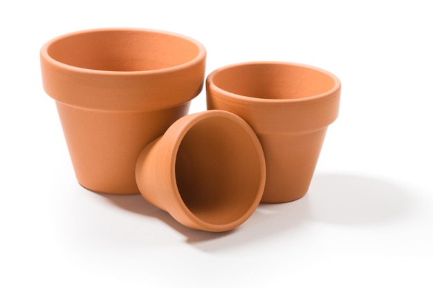 Three terracotta flower pots on white