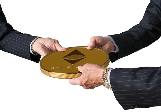 Three traders hands holding large ether or ethereum coin