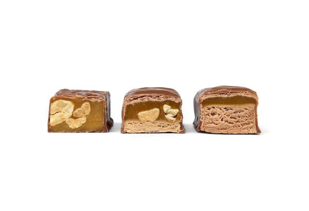 Three types of chocolate sweets with nougat, caramel and nuts.