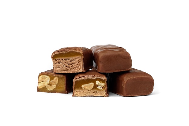 Three types of chocolate sweets with nougat, caramel and nuts.