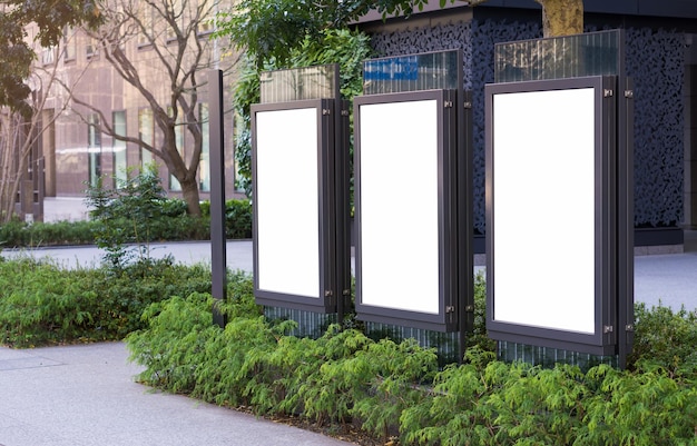 Photo three vertical billboards on the city streets