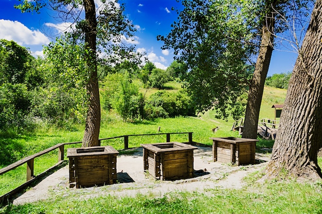 Three wells on the edge of the forest. Beautiful landscape