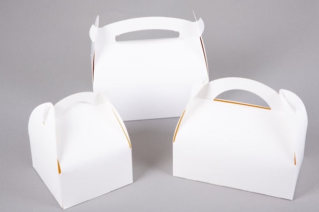 Three white blank closed pastry cupcake box mockup