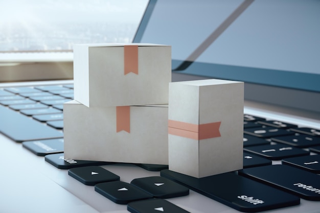 Фото Три белые картонные коробки на клавиатуре ноутбука