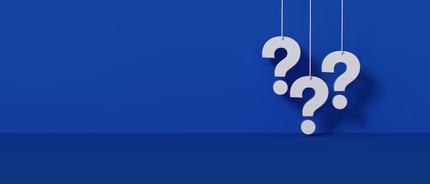 Three white question marks a blue wall background