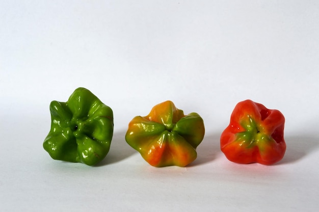 Three whole peppers of different colors