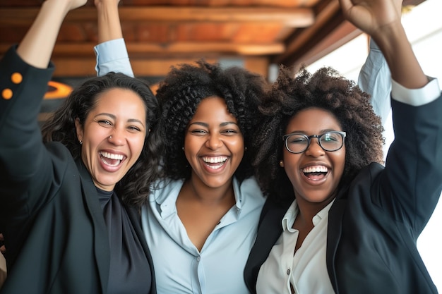 Three women celebrating professional success in the office teamwork work friends