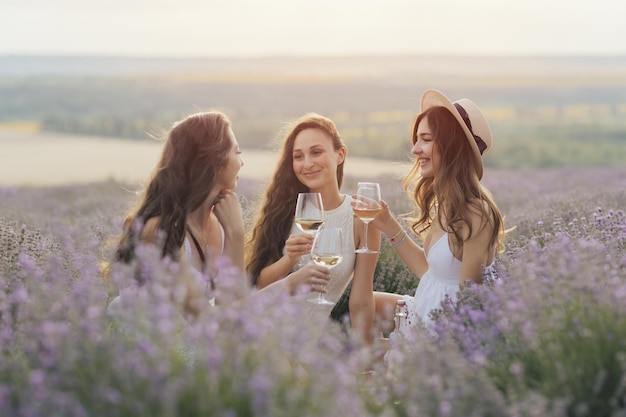 Three women sitting in a field of lavender