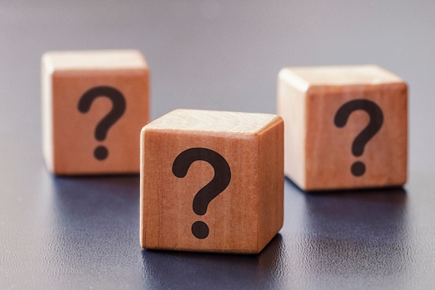 Three wooden blocks with question marks