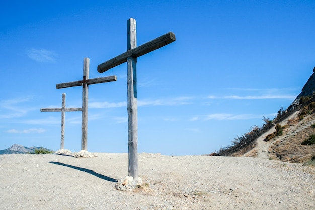 Three wooden cross in the highlands against the sky