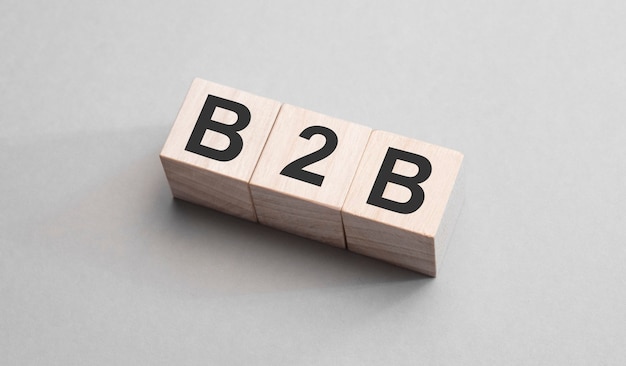 Photo three wooden cubes with letters b2b on grey background