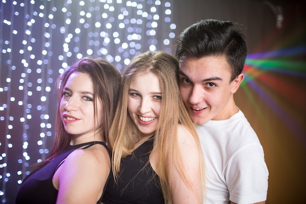 Premium Photo | Three young men and two women have fun in a nightclub at a  party