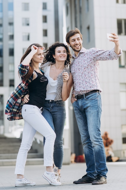 Three young people doing selfie