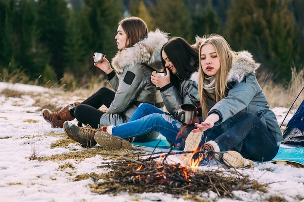 three young women in winter mountains