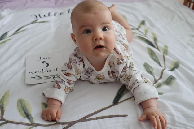 A threemonthold baby girl pure innocence in a pink blanket radiates joy in this photo