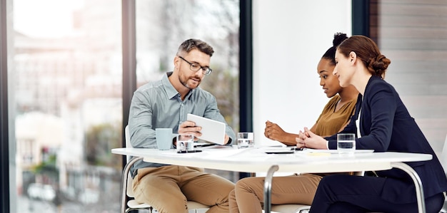 Threes company Cropped shot of three businesspeople working together in their office