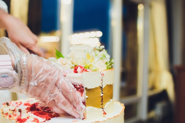 写真 白い木製のテーブルにマスティックの花で飾られた三層の白いウェディングケーキ メニューやコピースペースのある子カタログの絵