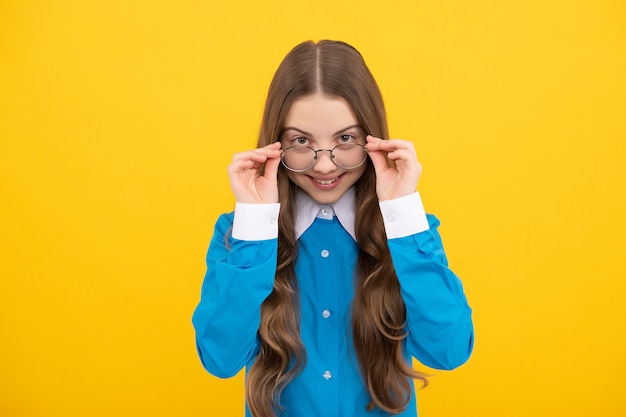 Through my eyeglasses I see just fine. Happy girl child wear eyeglasses. Trouble seeing. Vision correction. School education. Stay focused.