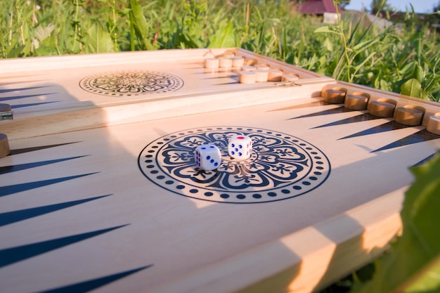 Throwing dice in backgammon board game close up Foreground soft focus