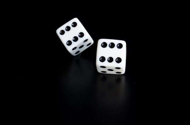 Thrown the dice on black background with reflection