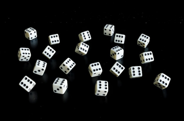 Thrown the dice on black background with reflection