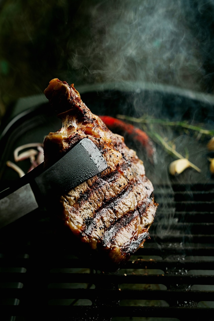Foto thuis rib eye steak grillen. natuurlijke rook. zomergrill, thuis koken concept