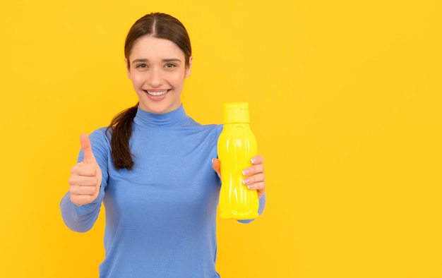 Thumb up be hydrated smiling woman hold mineral water feel thirsty young girl