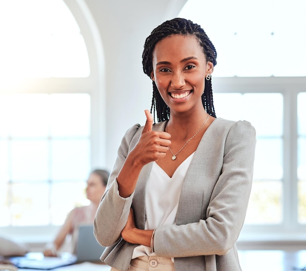 thumbs up business and portrait of black woman in the office with smile on face hand sign good job and success in business meeting at city office leadership congratulations and happy manager