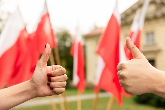 Thumbs up gesture with flags of Poland behind