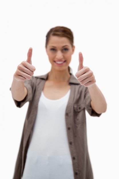 Photo thumbs up given by smiling woman