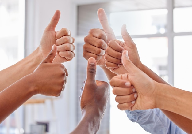 Thumbs up for teamwork Cropped shot of a group of unrecognizable people showing thumbs up in an office