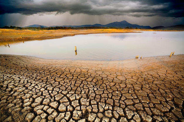 Thunder storm sky Rain clouds Cracked dry land without wate