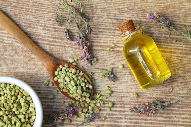 thymeOregano essential oil and Heap of dry thyme in wooden spoon and in bowl on wooden background