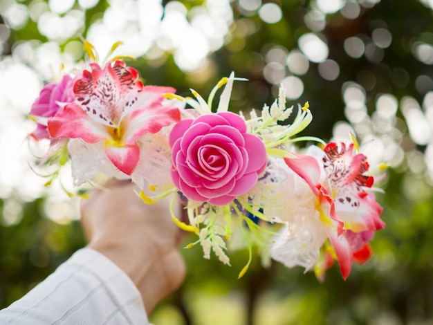 Tiara of artificial frower in hand. selective focus