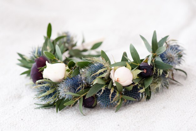 Tiara of artificial roses on wooden .