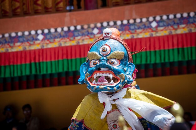 Tibetan man, dressed in a mystical mask, perform a dance during the Buddhist festival in Hemis monastery, Ladakh, India