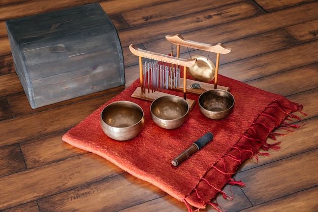 Tibetan singing bowls on the floor in yoga class, sound therapy concept