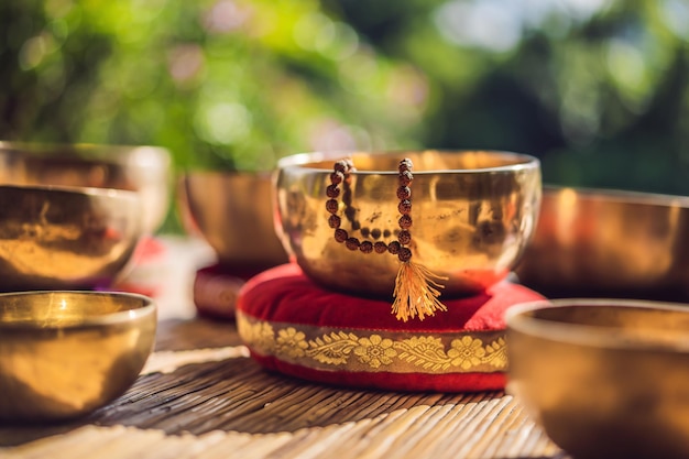 Tibetan singing bowls on a straw mat