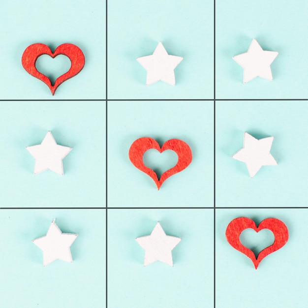 Photo tic tac toe game with red hearts and stars, symbol for love and emotion, valentines day